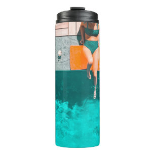 Woman lying beside swimming pool in the morning thermal tumbler