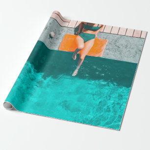 Woman lying beside swimming pool in the morning wrapping paper