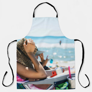 Woman lying on sun lounger covering her face with apron