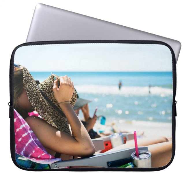 Woman lying on sun lounger covering her face with  laptop sleeve (Front)