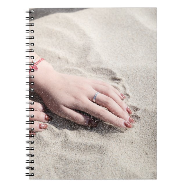 Woman lying on white sand notebook (Front)