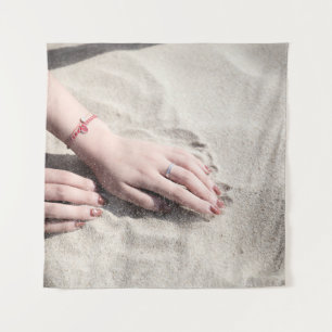 Woman lying on white sand tapestry