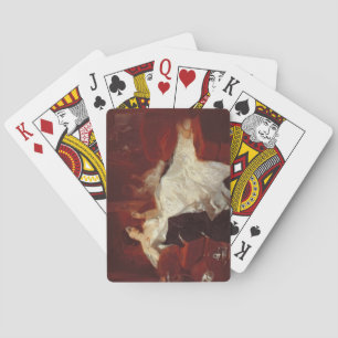 Woman on a red sofa playing cards