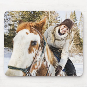 Woman on horse outdoors during winter mouse mat