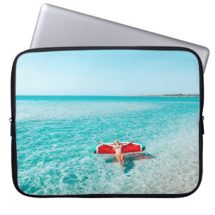 Woman on lilo in the sea water. Girl relaxing on i Laptop Sleeve