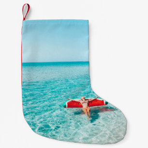 Woman on lilo in the sea water. Girl relaxing on i Small Christmas Stocking