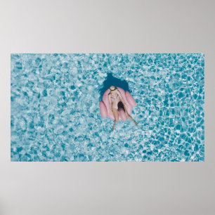 Woman on pink buoy surrounded by body of water in poster
