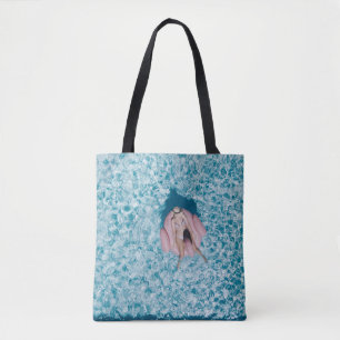 Woman on pink buoy surrounded by body of water in tote bag