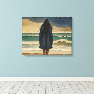 Woman on the beach looking out to sea canvas print