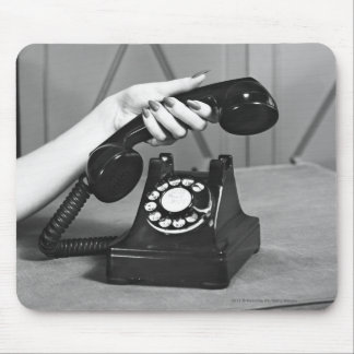 Woman picking up phone close up of hand mouse mat