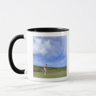 Woman playing golf mug