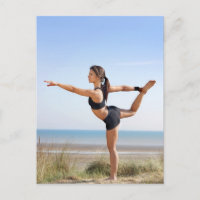 Woman practicing yoga on beach