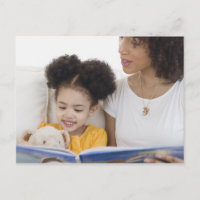 Woman reading book with daughter