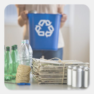 Woman recycling plastic bottles, cans and square sticker