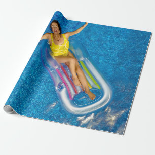 Woman riding on plastic floating buoy on body of w wrapping paper