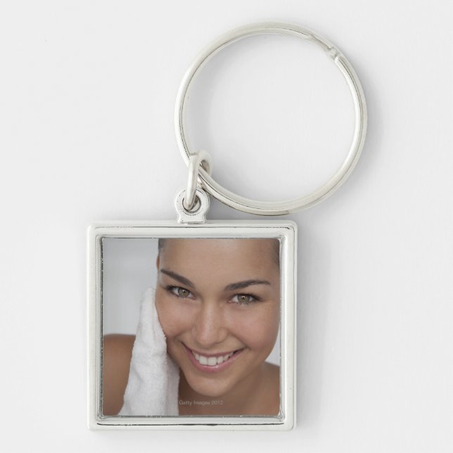 Woman scrubbing her face with cloth key ring (Front)