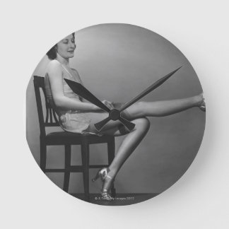 Woman Sitting on Chair Round Clock