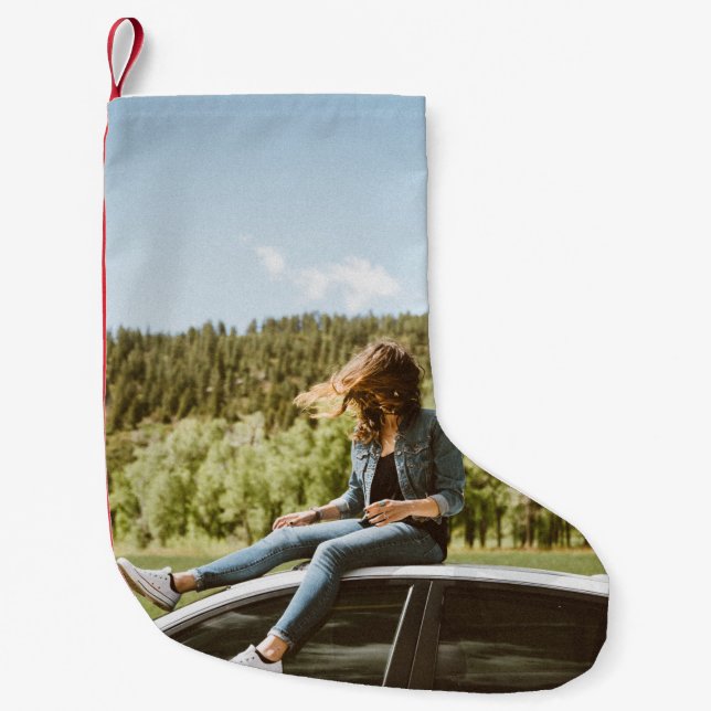 Woman sitting on roof of white sedan small christmas stocking (Front)