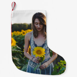Woman standing at sunflower field small christmas stocking