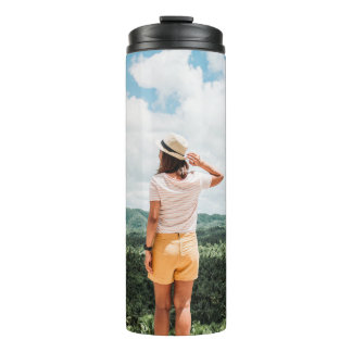 Woman standing near trees thermal tumbler