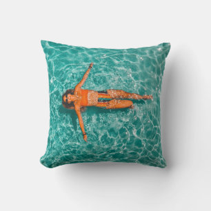 Woman swimming alone in body of water cushion