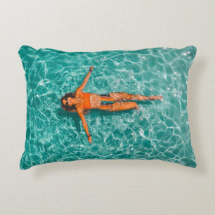 Woman swimming alone in body of water decorative cushion