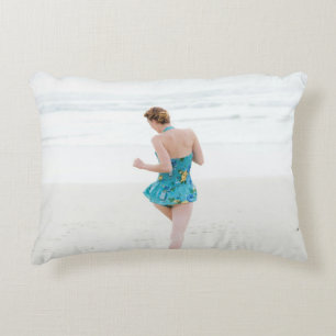 Woman walking on shore near beach decorative cushion