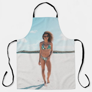 Woman wearing bikini standing on sand apron