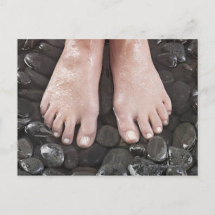 Woman's feet on pebbles postcard