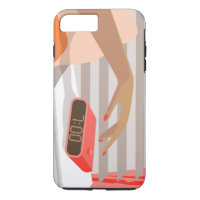Womans hand pushing on alarm clock snooze button