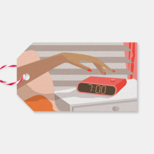 Womans hand pushing on alarm clock snooze button gift tags