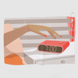 Womans hand pushing on alarm clock snooze button golf towel