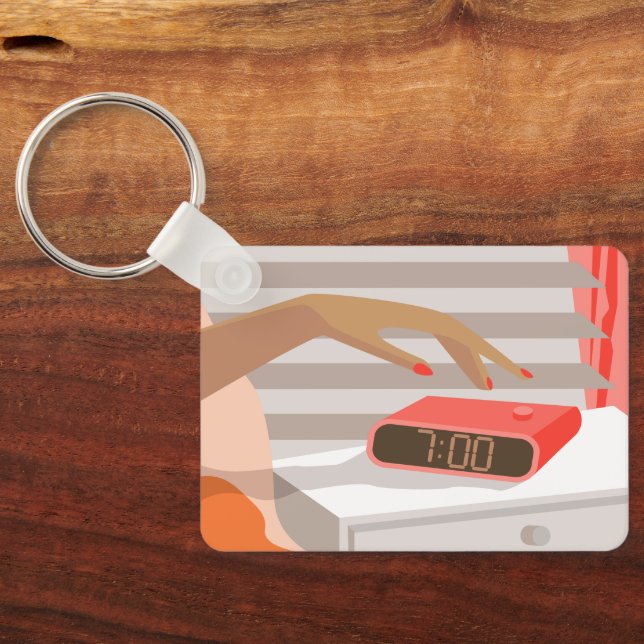 Womans hand pushing on alarm clock snooze button key ring (Back)
