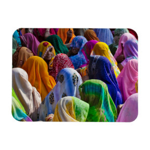 Women in colorful saris gather together magnet