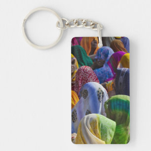 Women in colourful saris gather together key ring