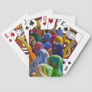 Women in colourful saris gather together playing cards