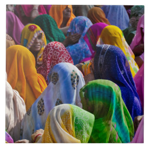 Women in colourful saris gather together tile