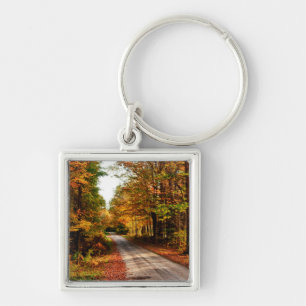 Wood trail with fall foliage key ring