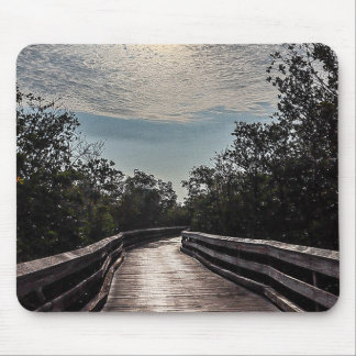 wooden boardwalk with clouds shining above mouse mat