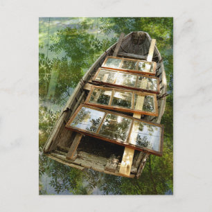 Wooden boat in a bed of rowan leaves postcard