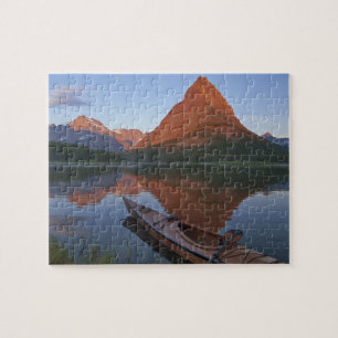 Wooden kayak in Swiftcurrent Lake at sunrise in Jigsaw Puzzle