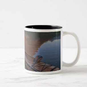 Wooden kayak in Swiftcurrent Lake at sunrise in Two-Tone Coffee Mug
