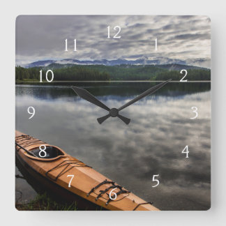 Wooden kayak on shore of Beaver Lake Square Wall Clock