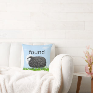 Wooly Black Sheep In Grass with "Found" Text Cushion