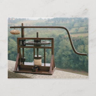 Working model of an olive press postcard