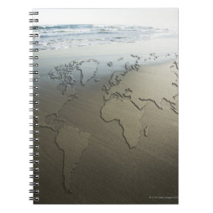 World map on sand notebook