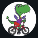 XX- Funny Dragon Riding Bicycle Classic Round Sticker<br><div class="desc">Hilarious cute green dragon riding a bicycle cartoon design is unique and fun and a great gift idea. He's full of personality. Can also add custom text and change background colour (click customise,  then edit,  then background) when ordering.</div>