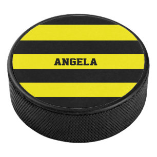 yellow and black stripes hockey puck