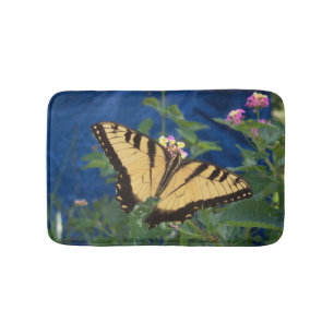 Yellow and black swallowtail butterfly on a bath mat
