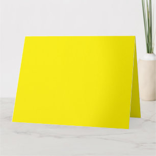 Yellow and orange abstract shapes overlap on a pla card